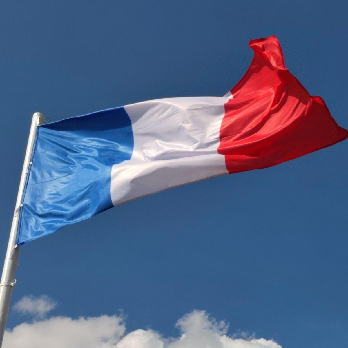 French flag and a blue sky.