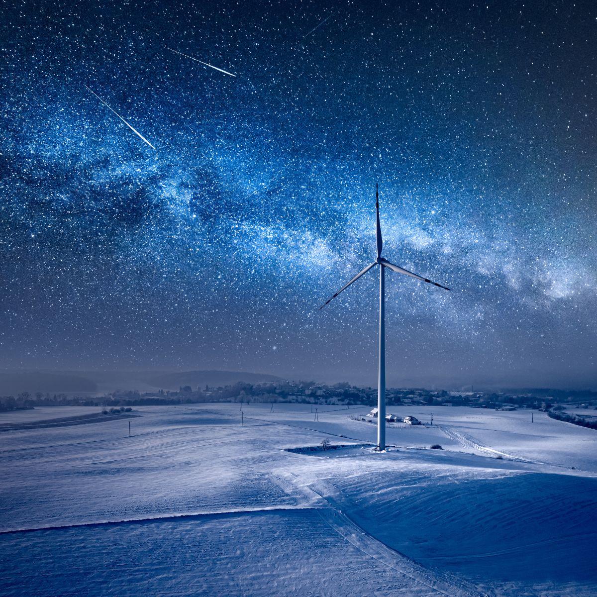 Milky way over wind turbine with ice on wind turbine in winter. Copyright: Shaiith/GettyImages/Canva